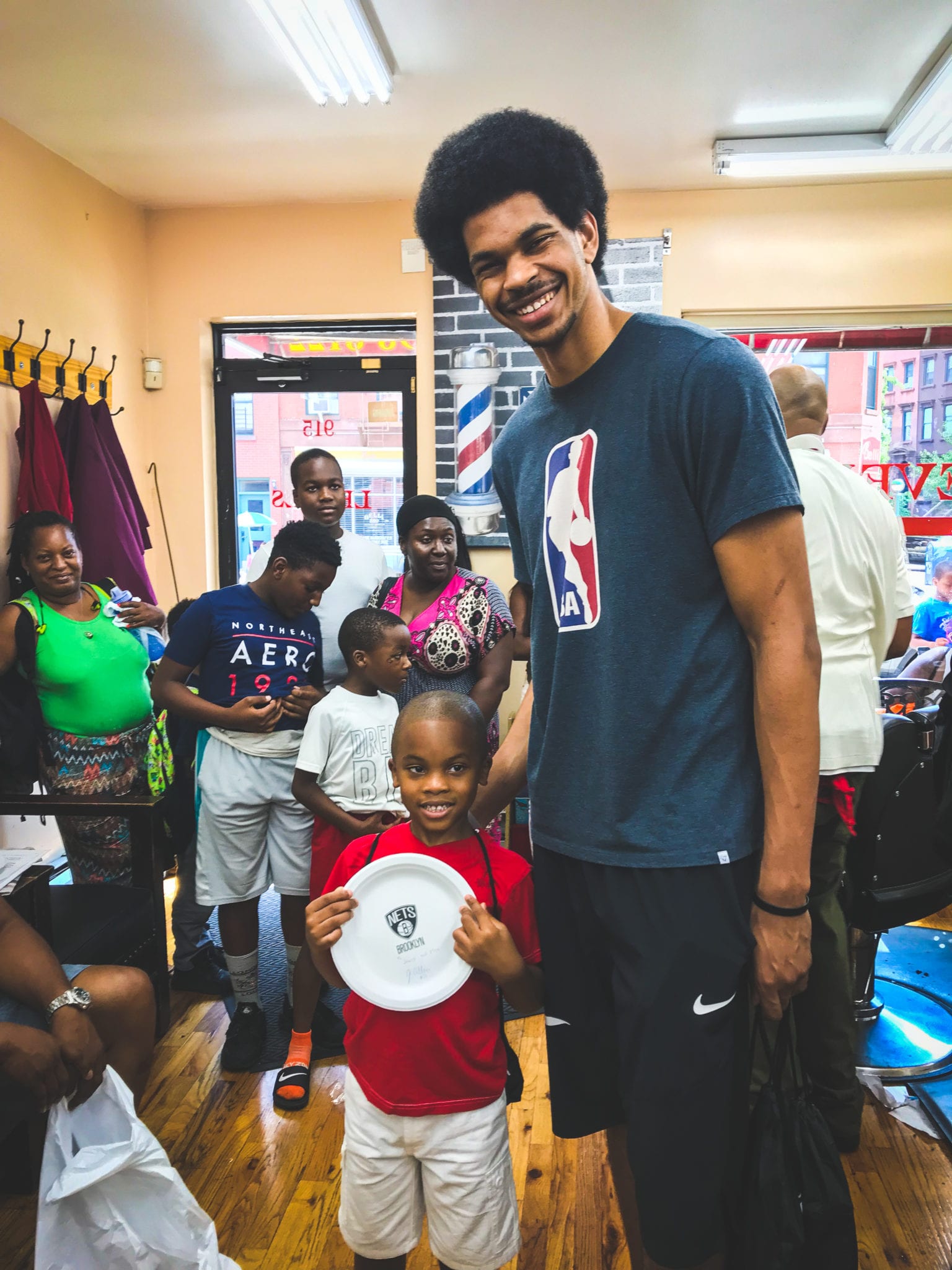 Nets big man Jarrett Allen poses with a fan at Levels Barbershop in Brooklyn. (Tandem SE)