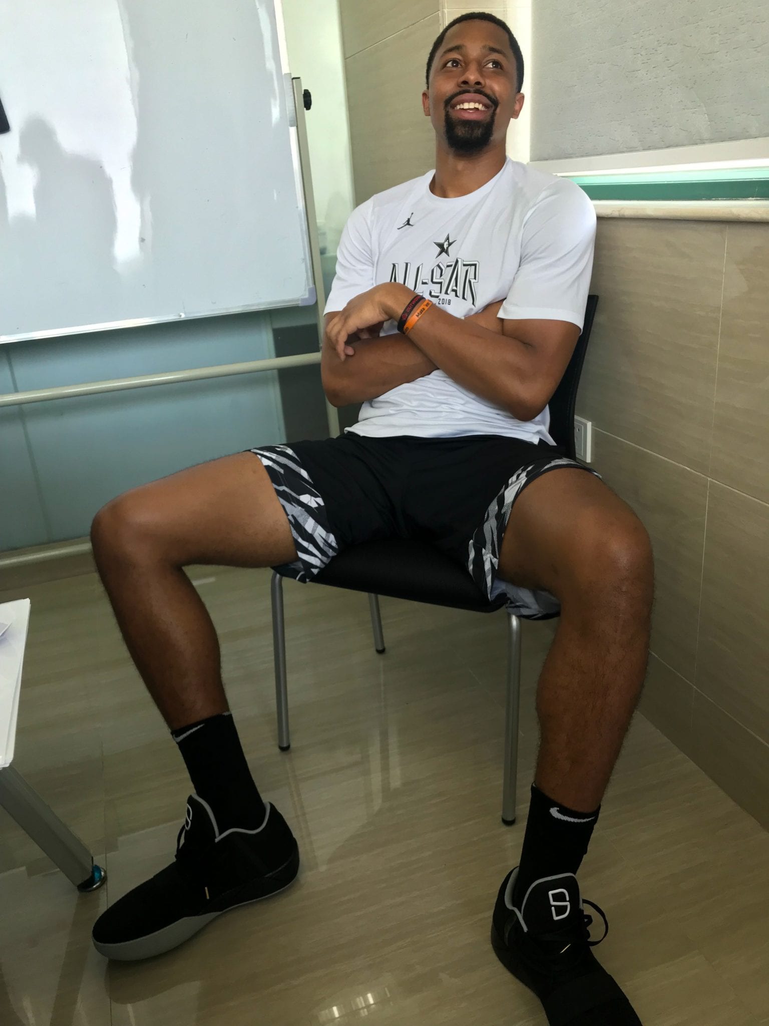 Spencer tries on his shoe for the first time in China. (Courtesy of Spencer Dinwiddie)